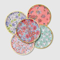 four plates with floral designs on them