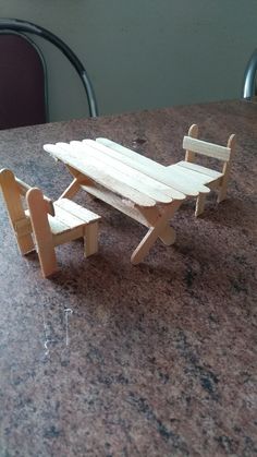 a wooden table and bench sitting on top of a counter