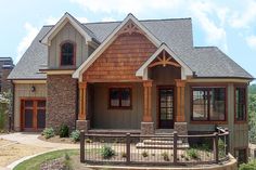 a house with brown shingles and wood trim