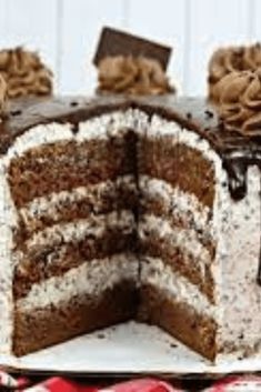 a chocolate cake with white frosting and brown icing