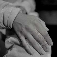 two hands holding each other in black and white