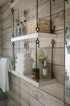 bathroom shelves with towels, soaps and other items on them