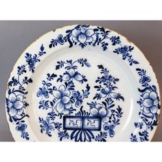 a blue and white plate with flowers on it