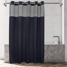 a bathroom with a black and grey shower curtain