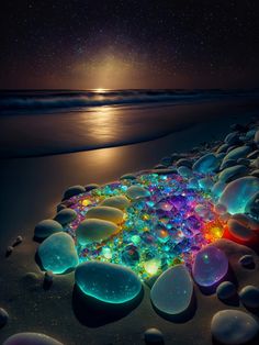 the beach is covered in glowing rocks and pebbles