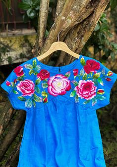 ❤ The blue hand embroidered dress is soft, skin friendly, breezy and comfortable.  ❤ Item description: - It's a lovely dress like a mini flower garden with colourful embroidered rose flowers motifs. - Material: linen fabric, button, hand embroidery. - Environmentally friendly. - This dress is very useful, go with any outfit, that can be used to go to school, go out, go shopping.    It is a perfect gift for yourself or your beloved.  ❤ Care instructions:      The best way to wash embroidery cloth is to put it in soapy water (with a mild detergent and cold water at 86 ºF/30oС) for 20 minutes. Try to not wash the item with other clothing that might cause damage, such as zippers, buttons or different colors. You wash it by hand, and if you have dirty patches on your garment, you can gently rub Summer Blue Embroidered Floral Print Dress, Blue Floral Print Embroidered Summer Dress, Traditional Light Blue Summer Dress, Blue Folk Dress For Spring, Blue Embroidered Dress For Spring, Blue Embroidered Dress With Neckline Detail For Spring, Casual Blue Dress With Floral Embroidery, Blue Bohemian Embroidered Dress For Summer, Light Blue Embroidered Floral Dress For Spring