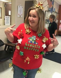 a woman wearing a red shirt with gold and green decorations on it