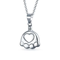 This stunning .925 silver cremation keepsake necklace features a pet paw print motif, elegantly commemorating your four-legged best friend. A sentimental heart in the center keeps your beloved pet forever close. Cremation Keepsakes, Puppy Paw Print, Urn Ashes, Jewelry For Ashes, Locket Necklaces, Puppy Paw Prints, Puppy Paw, Pet Paw Print, Pendant Locket