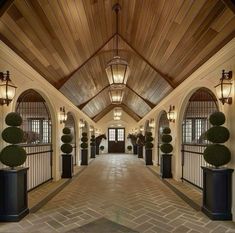 the entrance to an elegant house with large columns and arched doorways on either side