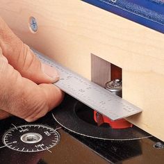 a person measuring the width of a piece of wood