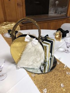 a small purse sitting on top of a table next to wine glasses and napkins