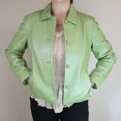 Stunning shimmery light green button up genuine leather jacket. Silky green soft lining. More of a boxy fit and a little cropped. Size women's US M.  Measurements  22.5 in top to bottom 19 in pit to pit  23.5 in arm length Casual Green Fitted Leather Jacket, Green Leather Jacket For Spring Workwear, Casual Green Leather Jacket For Work, Fitted Green Leather Jacket With Long Sleeves, Green Spring Outerwear With Snap Buttons, Green Outerwear With Snap Buttons For Spring, Green Leather Jacket For Work, Vintage Leather Jacket With Snap Buttons For Spring, Fitted Green Leather Jacket