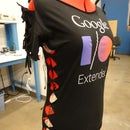 a woman's black shirt with the google logo is on display in a room