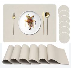 a white plate topped with food next to placemats and silverware on top of a table