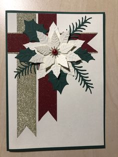 a white and green christmas card with poinsettis