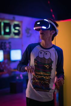 a woman in a t - shirt with a hamburger on it wearing a virtual headset