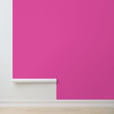 an empty room with bright pink walls and white trim on the wall, in front of a wooden floor