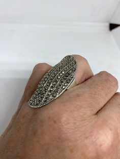 Vintage ring surrounded by Swiss cut fine Marcasite Sterling silver Size 6 can be sized by my jeweler. His service charge is $10-$20 All rings are shipped free in the US in a nice gift box. Check out our over a THOUSAND great reviews Engraving is $4 per letter and is not always perfect depending on the piece. It can take a few days if the jeweler is busy. This is payable to Paypal Judithsltd@gmail.com Antique Silver Diamond Ring Collectible, Nickel-free Silver Oval Crystal Ring, Silver Oval Diamond Ring With Stone Setting, Oval Silver Diamond Ring With Stone Setting, Art Deco Sterling Silver Diamond Ring Gift, Silver Diamond Ring With Stone Setting As Gift, Silver Diamond Ring With Stone Setting For Gift, Antique Silver Diamond Ring With Gemstone, Unique Silver Hallmarked Diamond Ring