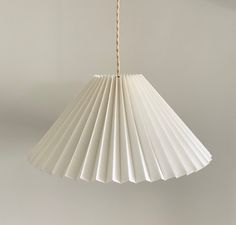 a white lamp hanging from a ceiling in a room