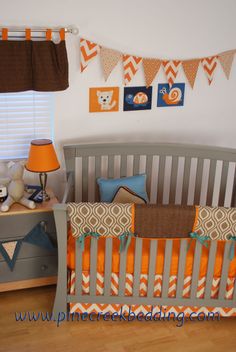 a baby crib with orange and blue decor