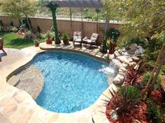 a small backyard with a pool and patio furniture