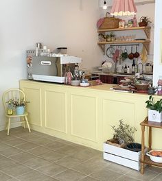 a kitchen filled with lots of counter space next to a wall mounted oven and coffee maker