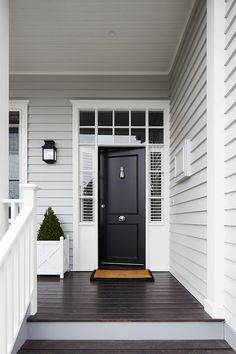 a black front door on a white house