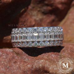 a diamond ring sitting on top of a rock