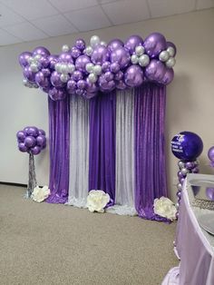 purple and silver balloons are on display in an office