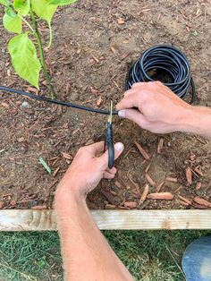 a man is working on a garden hose