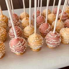 there are many desserts with white and pink frosting on the cake pops together