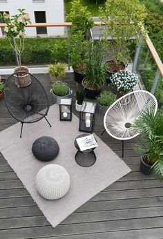 an outdoor deck with various plants and furniture