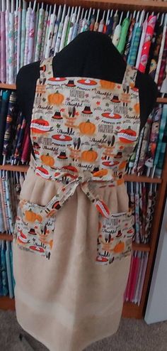 an apron is on display in front of a bookcase