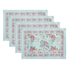 three place mats with pink roses on them