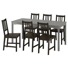 a dining table with six chairs next to each other on a white background in front of a white backdrop