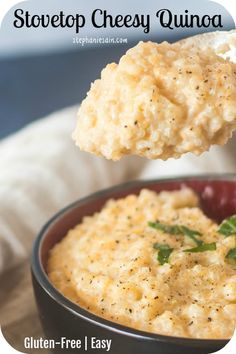 a spoon full of cheesy quinoa is being lifted from a bowl