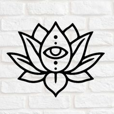 the lotus symbol on a white brick wall