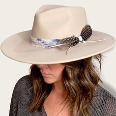 The Amelia is made from 100% Australian wool felt and has a classic wide cut brim, featuring a jute rope tie and feather trim. Details 100% Australian wool felt Brim: 3.75"Crown: 4.5"Size: O/S with a size adjuster for customizable sizing capability. The velcro ribbon size adjuster is tucked into the sweatband on the inside of the hat. How to clean: Spot clean using a damp cloth and mild soap. Air dry in an area free from direct sunlight. Western Fur Felt Fedora For Spring, Western Style Fur Felt Fedora For Spring, Winter Fedora Hat With Feather Trim, Winter Fedora With Feather Trim, Western Wool Hat Band For Spring, Western Wool Hat Bands For Spring, Spring Adjustable Fur Felt Fedora, Adjustable Beige Fur Felt Fedora, Adjustable Fur Felt Fedora For Spring