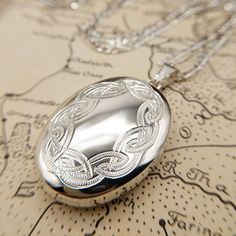 Metal: Sterling Silver Locket Size: 3.4cm x 2.6cm Locket Weight: 8.1 grams Hallmarked: Yes Chain Length: 20, 22 & 24 inch Chain Weight: 5-7 grams Link Style: Figaro, 2mm wide Hallmarked: No (under 7.78 grams) A fabulous quality large oval locket with an engraved celtic knot design the front. The locket is made from solid sterling silver and it has two spaces inside for photos. Available on a sturdy silver figaro chain 20-24 inches in length. Fantastic, hand made in Britain jewellery. *RETURNS* W Luxury Silver Oval Pendant Locket Necklace, Silver Figaro Chain, Silver Locket Necklace, Celtic Knot Designs, Sterling Silver Locket, Oval Locket, Silver Locket, Knot Design, Figaro Chain