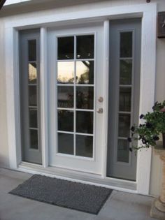 a white double door with glass and sidelights