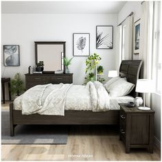 a bedroom with a bed, dresser and mirror