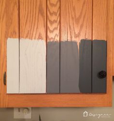 kitchen cabinets painted in different shades of gray and white with wood grains on the doors