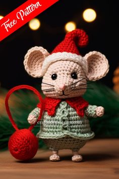 a crocheted mouse with a red hat and scarf