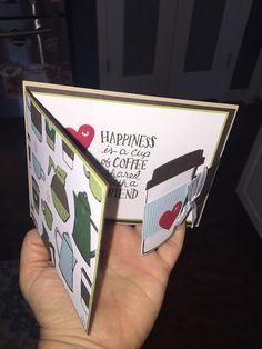 someone holding up a card that says happiness is a cup of coffee on the inside