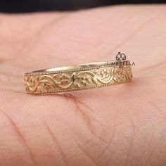 a close up of a person's hand with a wedding ring on it,