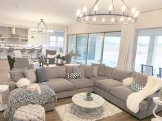 a living room filled with furniture and lots of windows