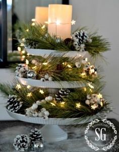 a christmas tree decorated with pine cones and candles