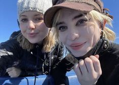 two young women posing for the camera on a sunny day