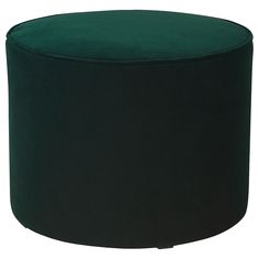 a green round ottoman sitting on top of a white floor