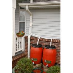 two large red barrels sitting in front of a house